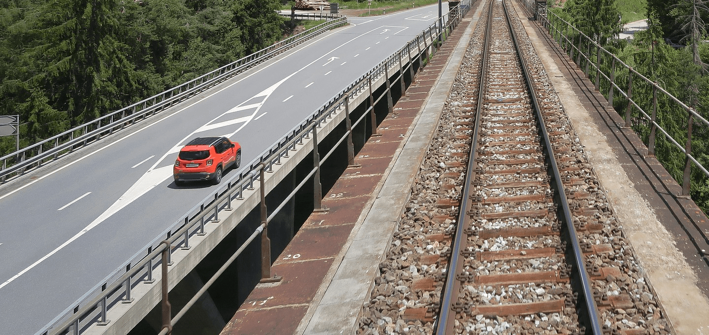A road and railroad track run parallel to each other.